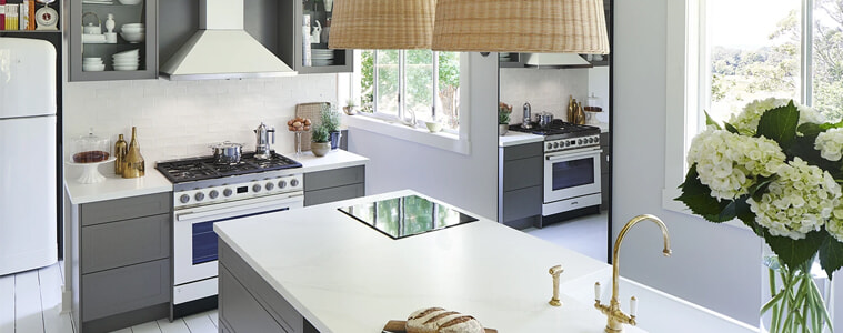 A grey kitchen with updated modern appliances.