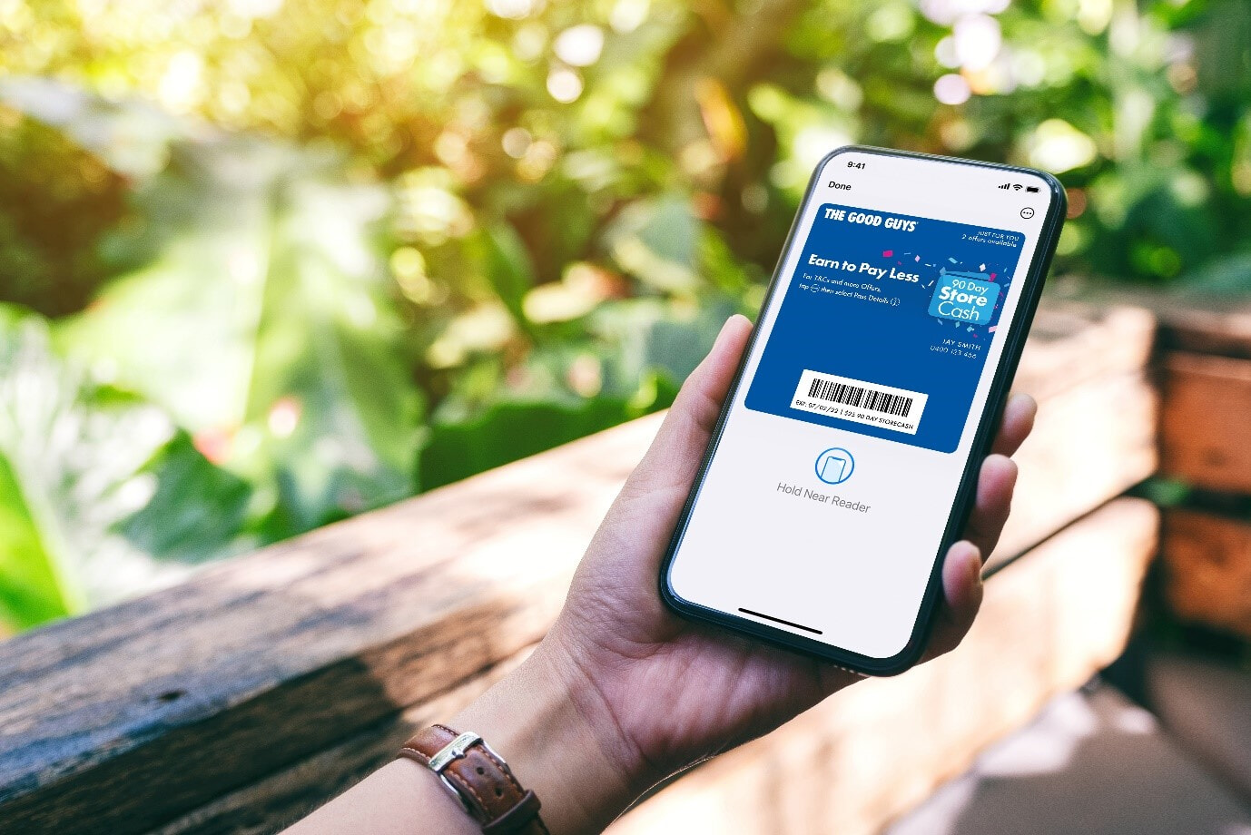 A woman opens The Good Guys StoreCash digital wallet on her smartphone to check on latest offers and deals.