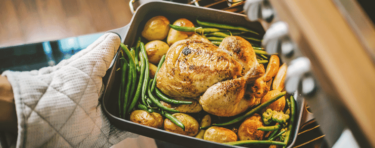 image of roast chicken coming out of an oven