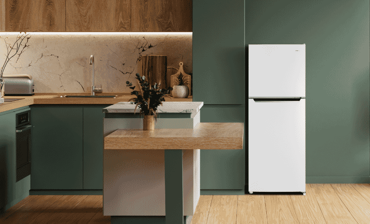 A white CHiQ fridge sits in a grey kitchen with white walls.