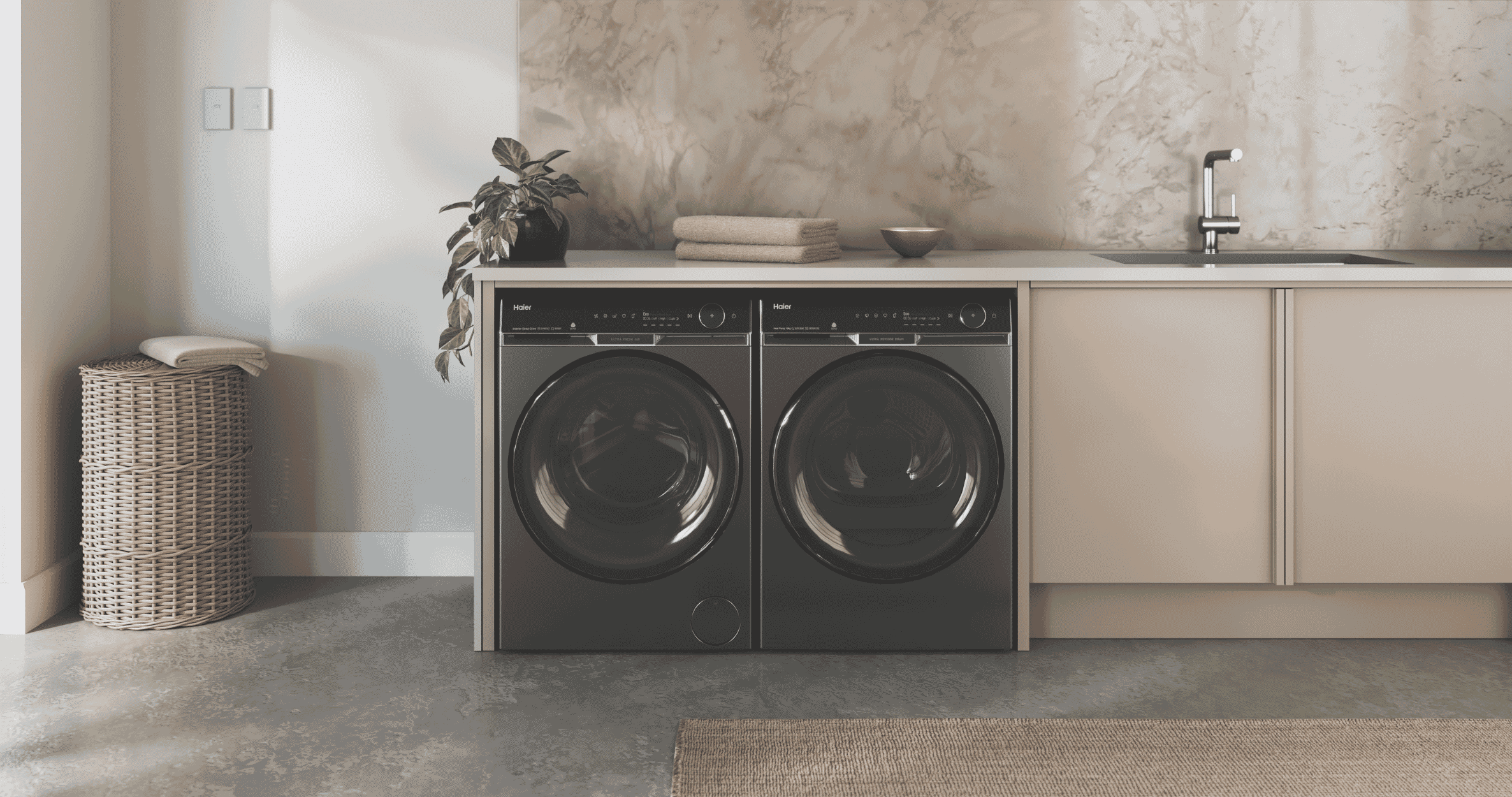 Haier washer and dryer sitting side by side in modern laundry