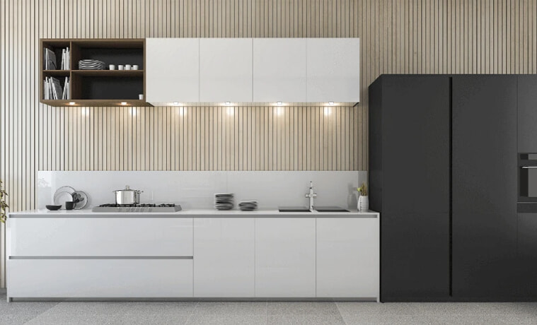 A white modern kitchen with a black fridge.