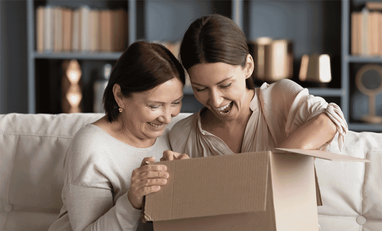 Mother and daughter opening a gift box