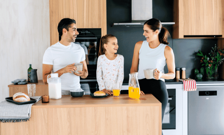 Family having breakfast together in the kitchen surrounded by Beko appliances