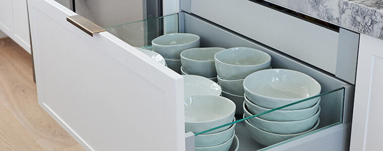 Plates and bowls are easily seen from all angles in a glass sided kitchen drawer, part of the Kinsman design.