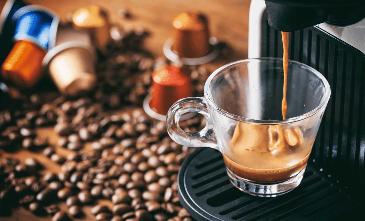 Coffee Pod Machine pours a beautiful coffee on a table with coffee beans and coffee capsules