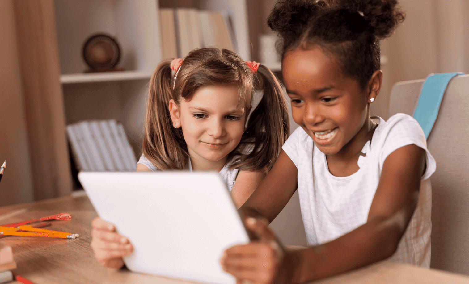 Two girls using a laptop to learn from home