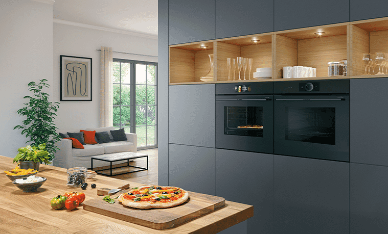 Pizzas being made in a modern kitchen featuring dual Bosch Series 8 Ovens 