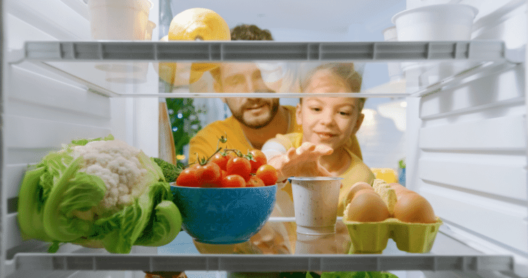 A father and son looking into the fridge