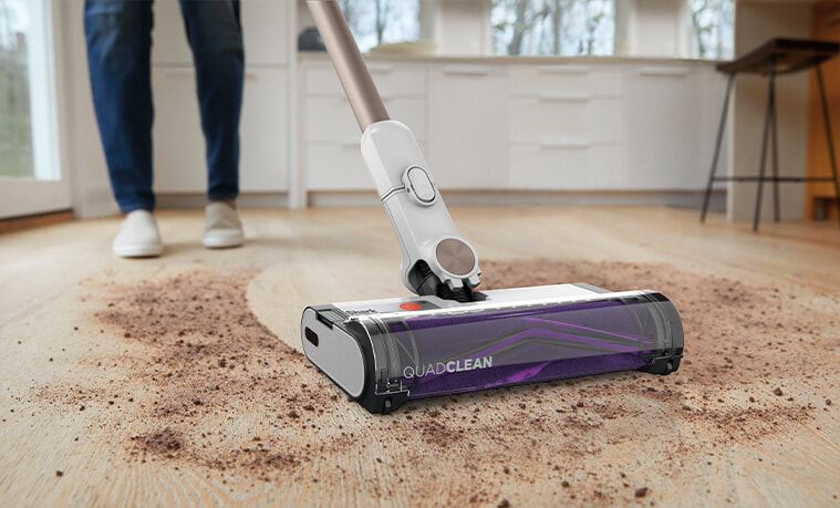 The Shark Auto Detect Pro being used to vacuum dirt in a modern home
