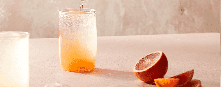 A glass filled with aarkes grapefruit ginger mocktail recipe 