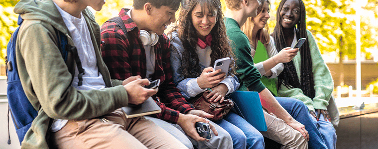 Teens using smartphones at school