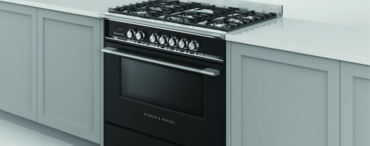 A black freestanding cooker in a white kitchen.