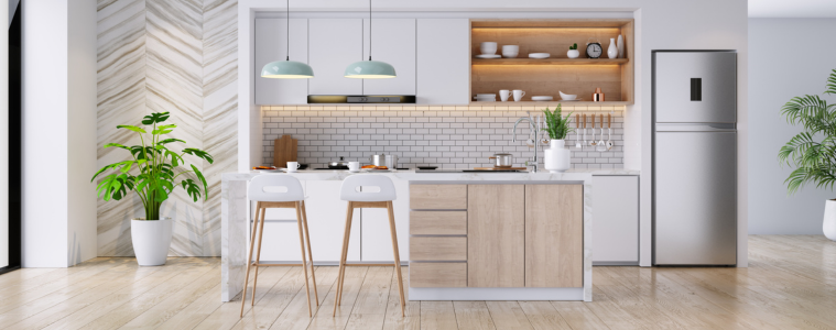 A modern kitchen with a silver top mount fridge.