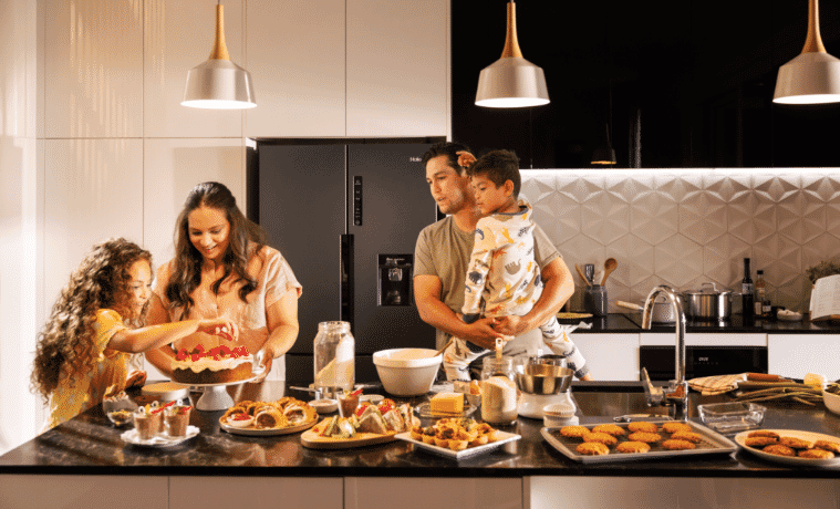 Family enjoying a range of foods prepared with the Haier range