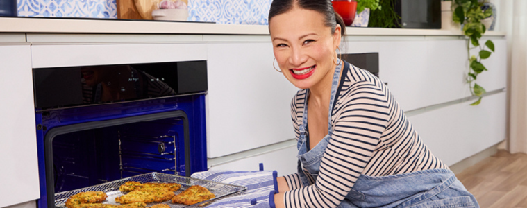 Image of Poh Ling Yeow putting chicken parma's into the LG oven