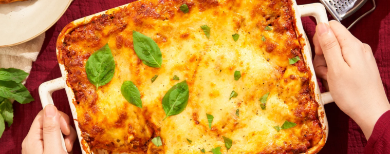 Close-up image of a baked lasagna dish in a casserole tray.