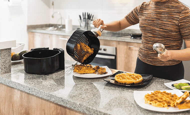 Woman serving fried chicken with air fryer waffles
