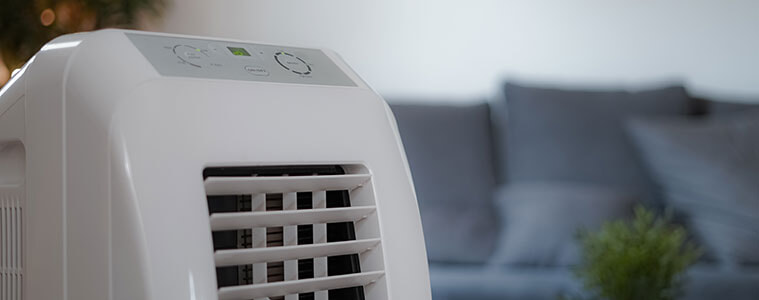 Close up of the grill of a portable air conditioner in the living room