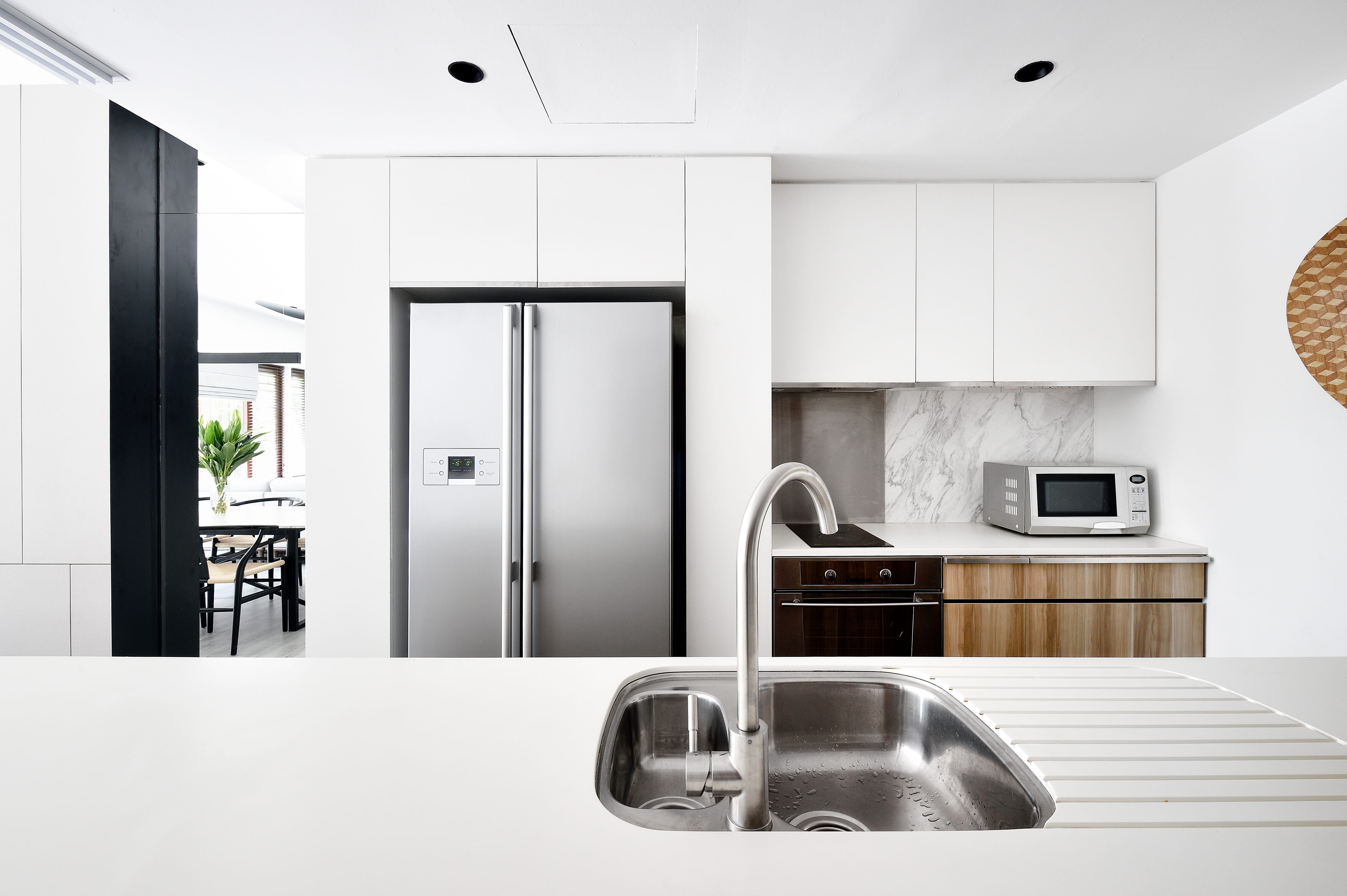 A stylish side by side fridge freezer in a modern white kitchen