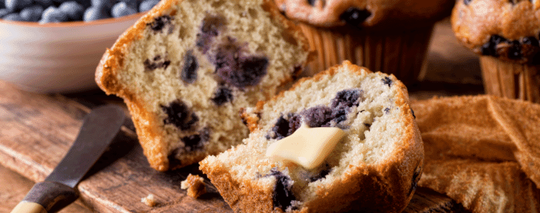 Fresh baked blueberry muffins with melted butter