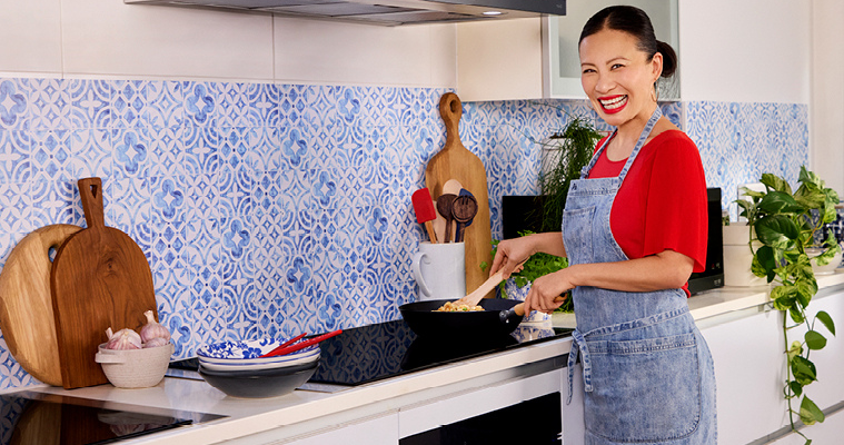 Image of Poh Ling Yeow happily cooking on an LG induction cooktop