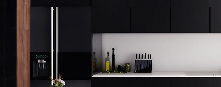 Side by side black fridge with stainless steel handles in a luxury apartment kitchen.