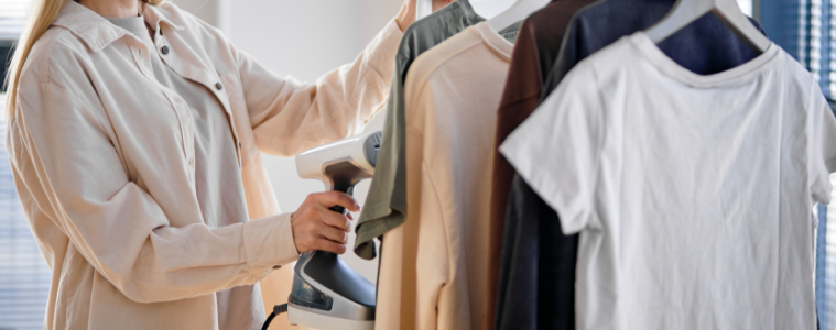 a woman hand steaming her clothes 