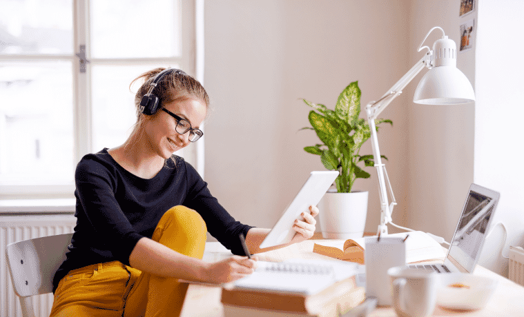 A woman working from home sitting at her desk