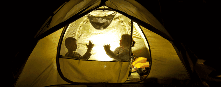 kids playing outside in a tent