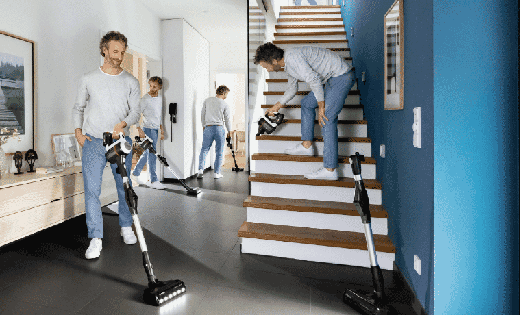 a man vacuuming his house using the Bosch Unlimited 7 Vacuum 