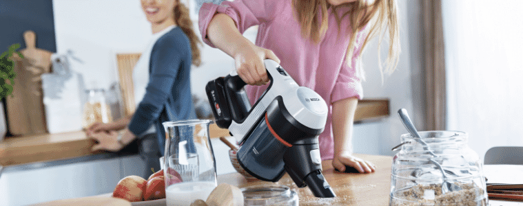 a little girl cleaning the bench with the Bosch Unlimited 7 Cordless Vacuum White