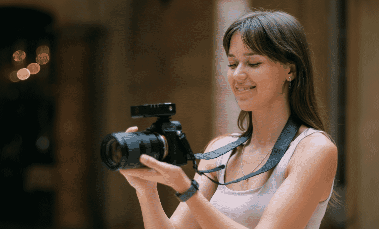 a woman standing with a camera about to take a photo 