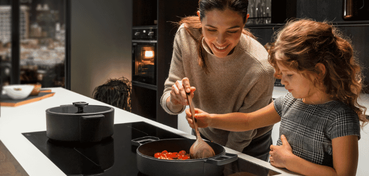 A mother and daughter making dinner on their DeLonghi induction cooktop