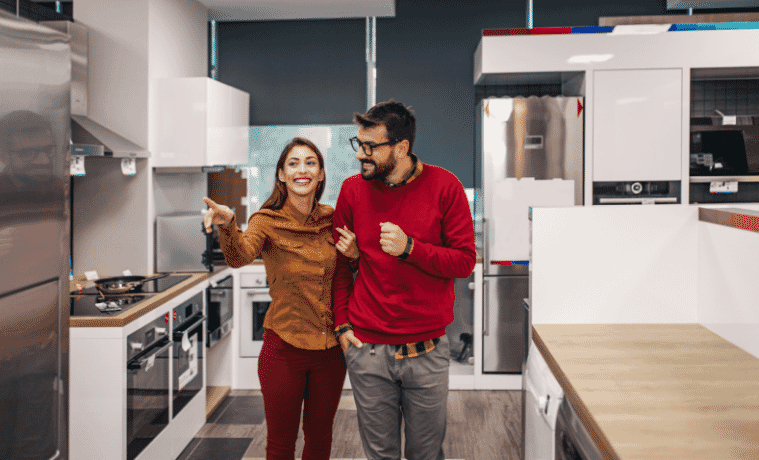 a man and woman shopping for a new fridge