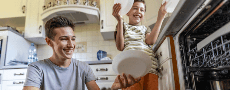 two brothers unpacking the dishwasher