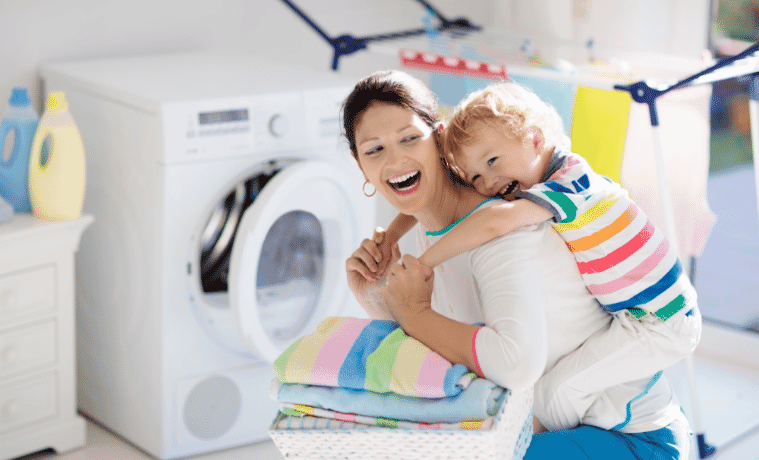 A mum with her son on her back in the laundry room 