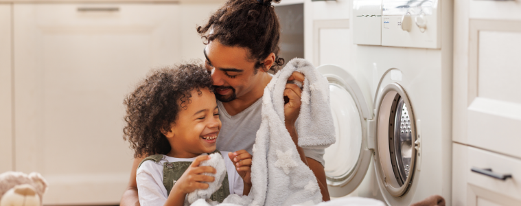 A father and son doing laundry together 