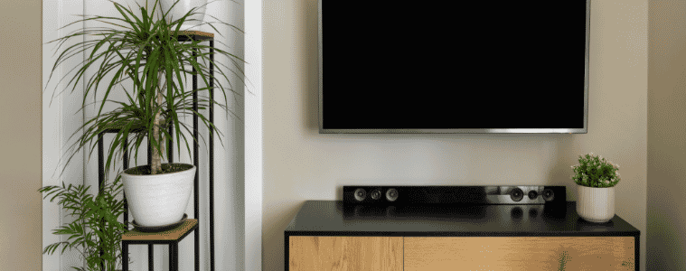 a TV and soundbar in a loundroom  