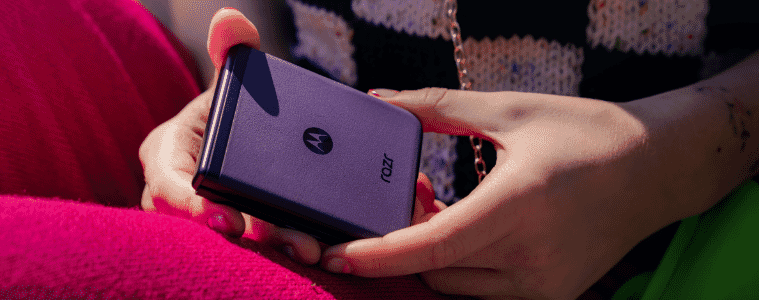 A woman holding a purple motorola razr 40 phone 