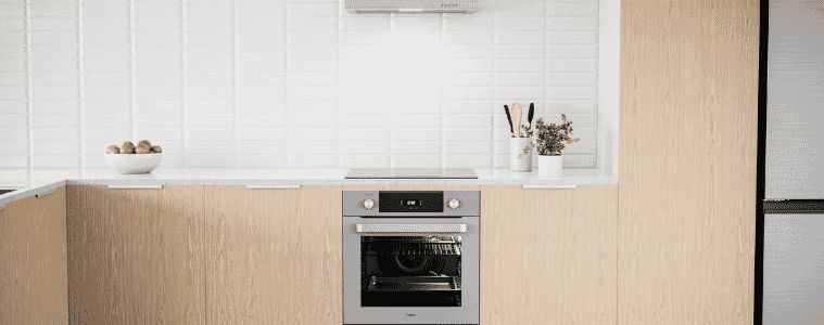 mid grey Haier oven in a pale pink kitchen 
