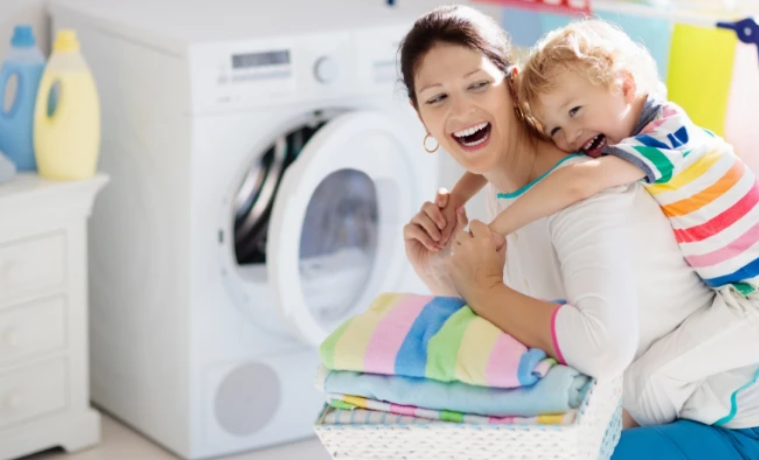 A mum with her son on her back in the laundry room 